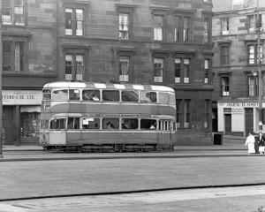 A black and white picture of a double-decker tram